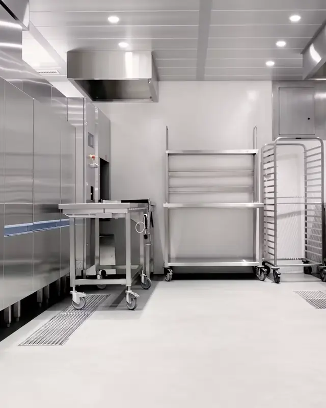 Cozinha profissional em aço inoxidável, com carros e prateleiras